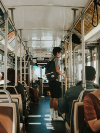 Rear view of man traveling in train