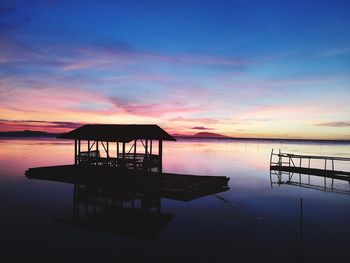 Silhouette pier on sea against sky during sunset