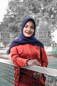 Portrait of smiling girl standing in snow
