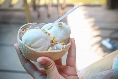 Close-up of hand holding ice cream