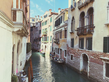 Canal amidst buildings in city