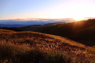 Scenic view of landscape against sky during sunset