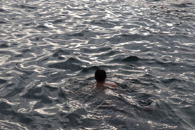 High angle view of man swimming in sea