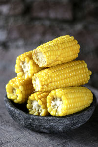 Close-up of corns in bowl on wooden table