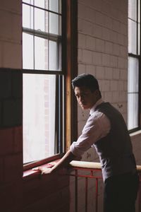 Man standing at window