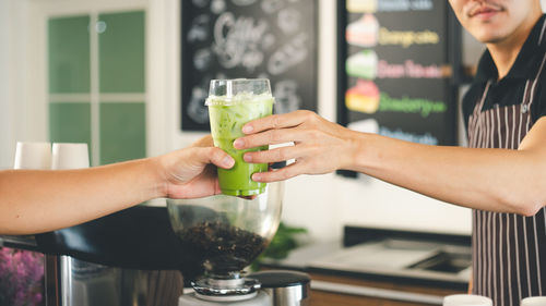 Midsection of woman holding drink