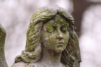 Close-up of angel statue in cemetery