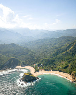 High angle view of sea and mountains against sky