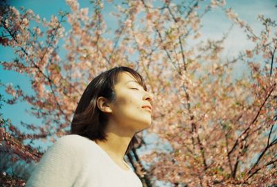 Woman wearing hat against trees