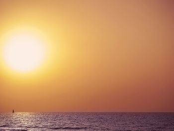 Scenic view of sea against orange sky