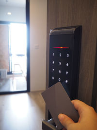 Woman's hand used key card access smart digital door systems for unlocking and entry the room.