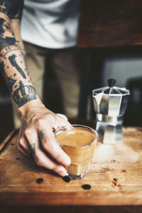 Midsection of coffee cup on table