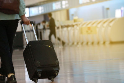 Man holding umbrella while standing at airport