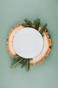 Festive christmas natural style table setting with white plate on wood cut platters