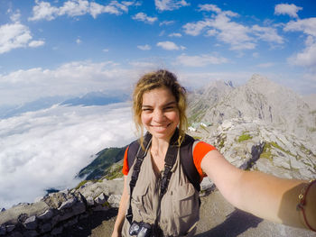 Young happy woman on vacations taking selfie