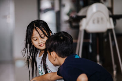 Girl with brother at home