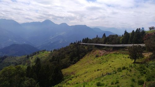 Scenic view of landscape and mountains against sky