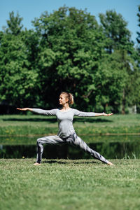 Full length of woman sitting on field