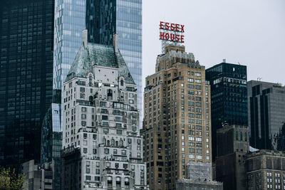 Low angle view of modern buildings in city against sky