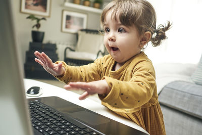 Adorable baby with a laptop