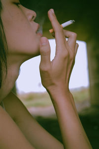 Close-up of woman hand holding cigarette