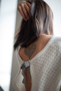 Rear view of woman with tattoo