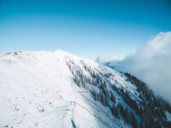 Scenic view of snow mountains against clear blue sky