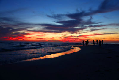 Scenic view of beach against sky during sunset