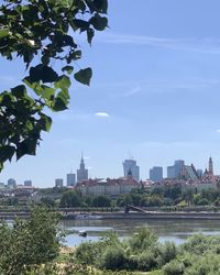 View of buildings at waterfront against cloudy sky