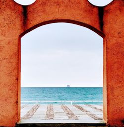 Scenic view of sea against sky seen through window