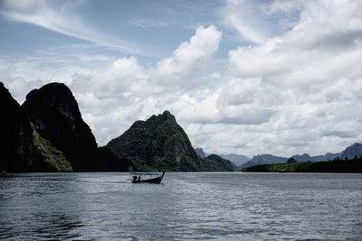 Scenic view of sea and mountains against sky