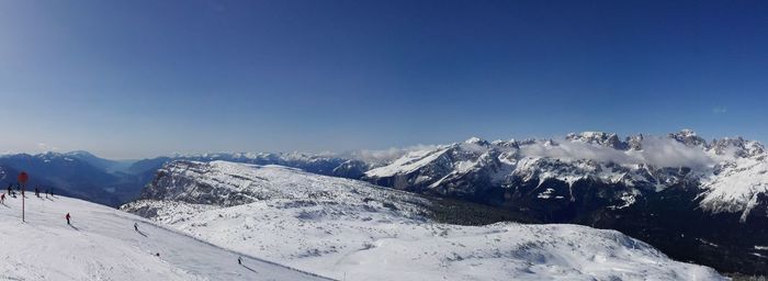 Scenic view of snowcapped mountains against clear blue sky