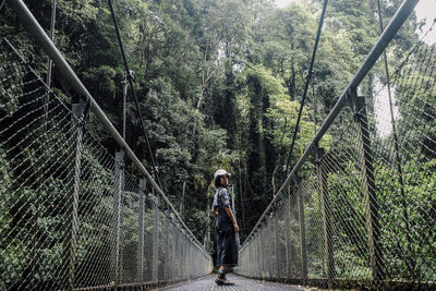 Rear view of woman walking in forest