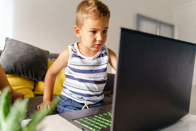 Boy using mobile phone at home