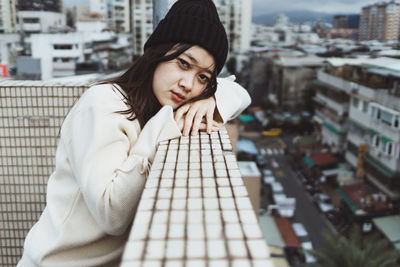 Portrait of young woman in city