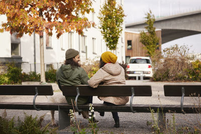 Man and woman sitting on bench