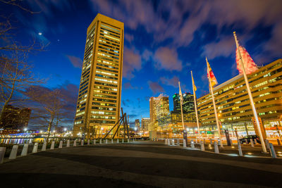 Illuminated buildings in city against sky at night