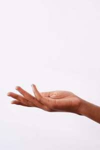 Close-up of human hand against white background