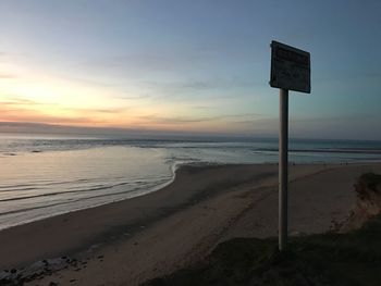 Scenic view of beach against sky during sunset