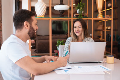 Young woman using laptop at home