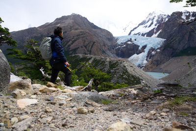 Rear view of man walking on mountain