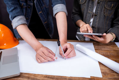 Low section of people working on table