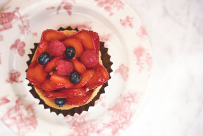 Fresh homemade fruit tart with strawberry isolated on white table, top view. selective focus.