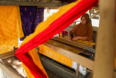 Rear view of woman sitting on hammock