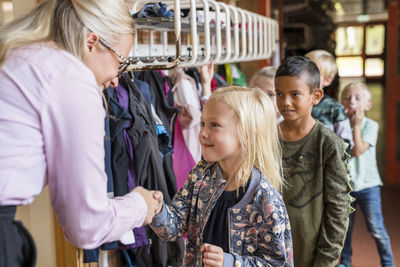 Teacher greeting children