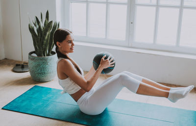 Young woman exercising at home