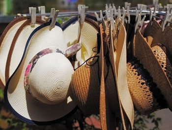 Sunhats hanging on metal