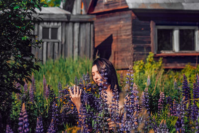 Full length of woman holding flowering plants