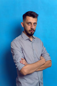 Portrait of a man with a beard on a blue background