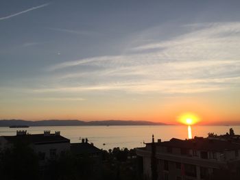 Silhouette buildings against sky during sunset